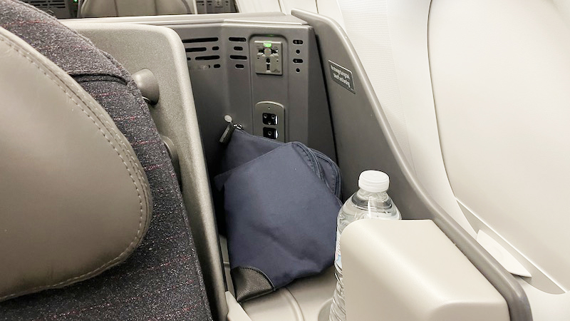 a bag and a bottle in a seat