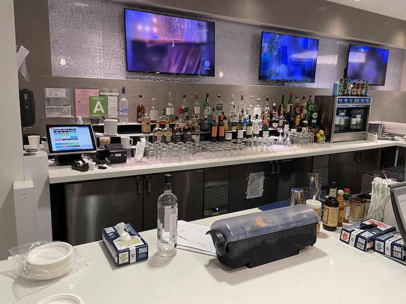 a bar with many bottles and glasses