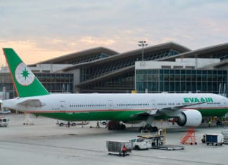 a large airplane parked in front of a building