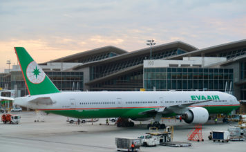 a large airplane parked in front of a building