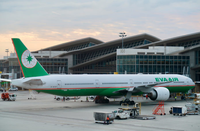 a large airplane parked in front of a building