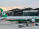 a large airplane parked in front of a building