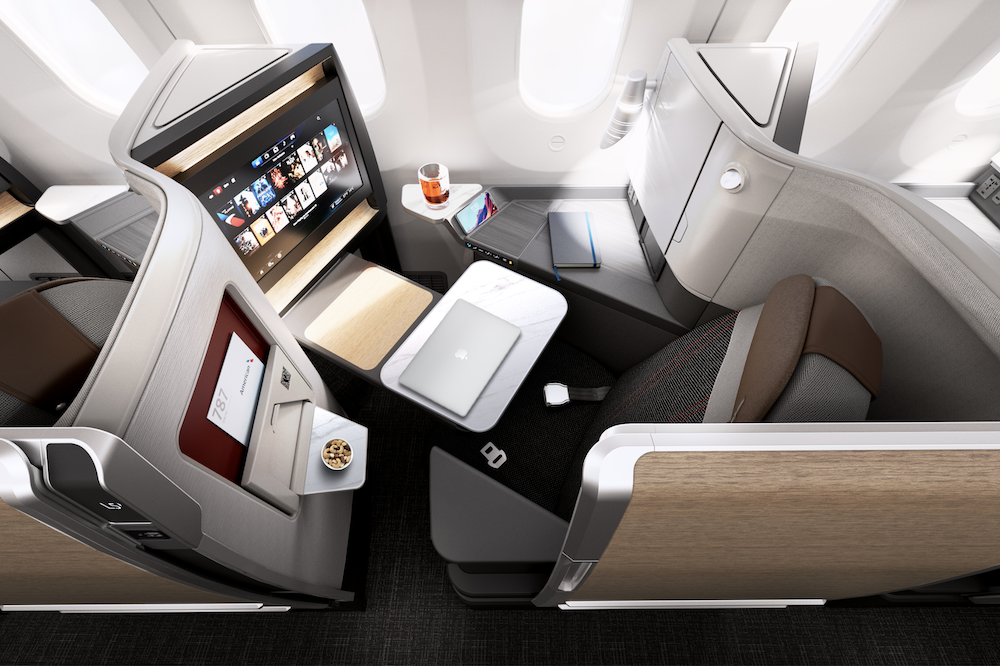 an airplane with a laptop and a tv