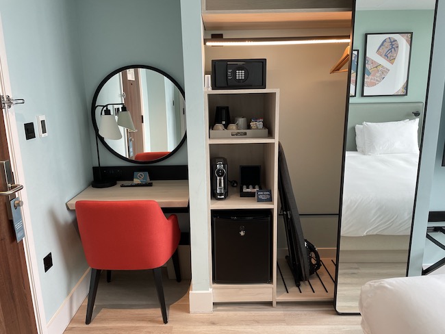 a room with a mirror and a desk