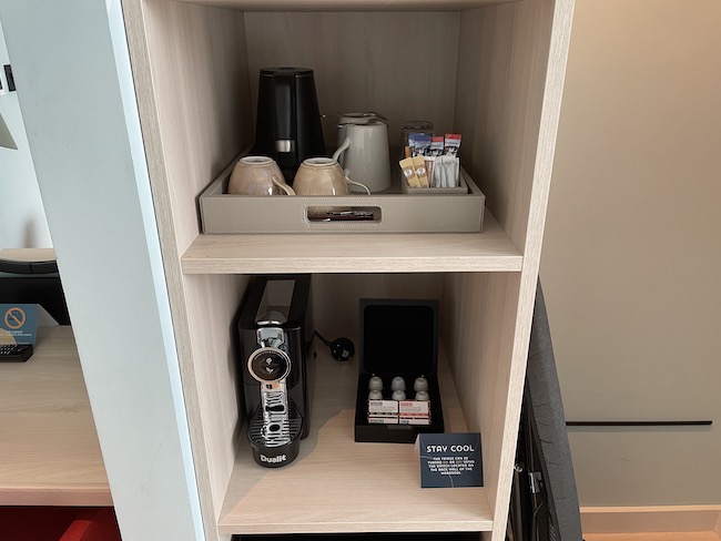 a shelf with a tray of coffee and other items