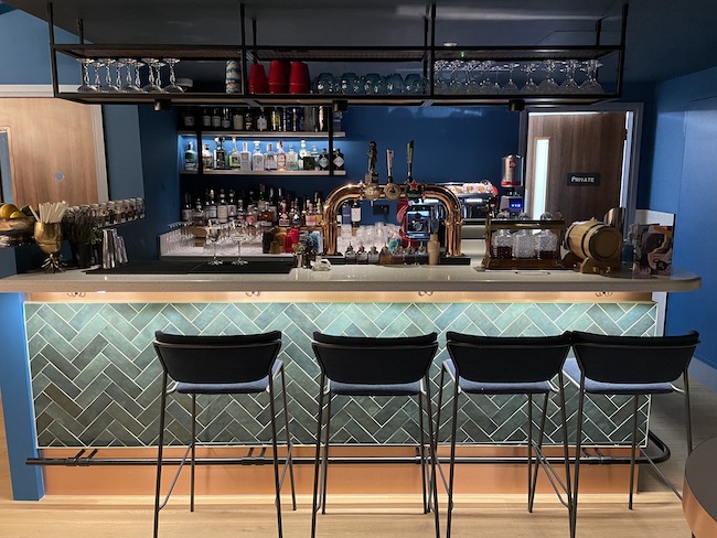 a bar with a row of chairs and a bar