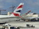 a group of airplanes at an airport