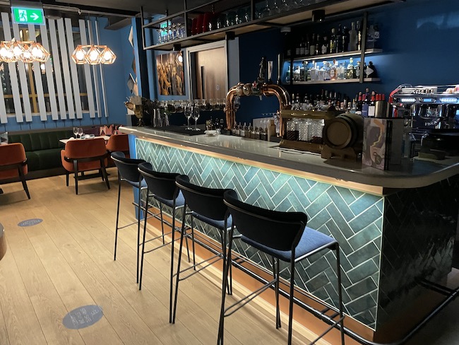 a bar with blue walls and chairs