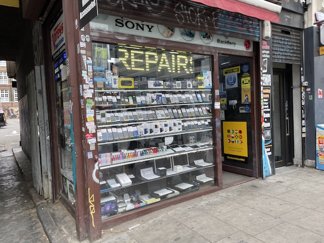 a store front with a display of electronics