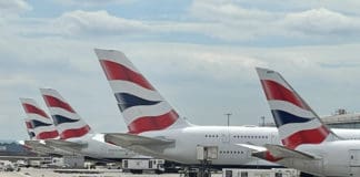 a group of airplanes parked at an airport