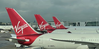 a group of airplanes parked at an airport