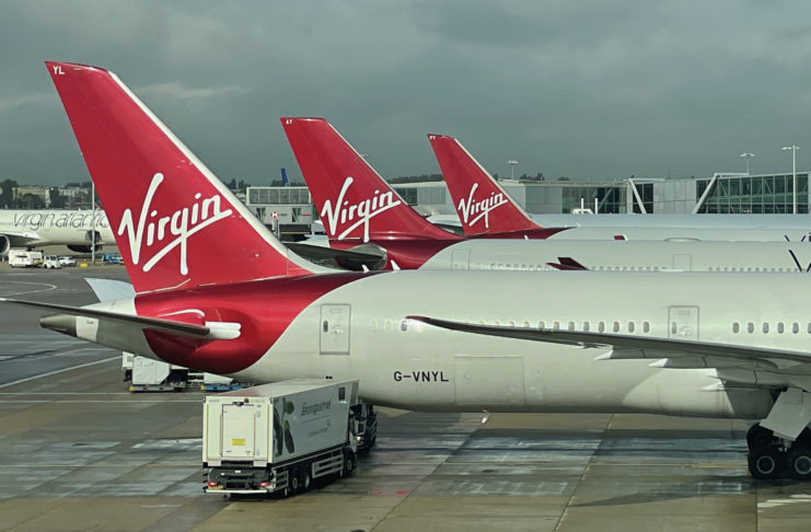 a group of airplanes parked at an airport