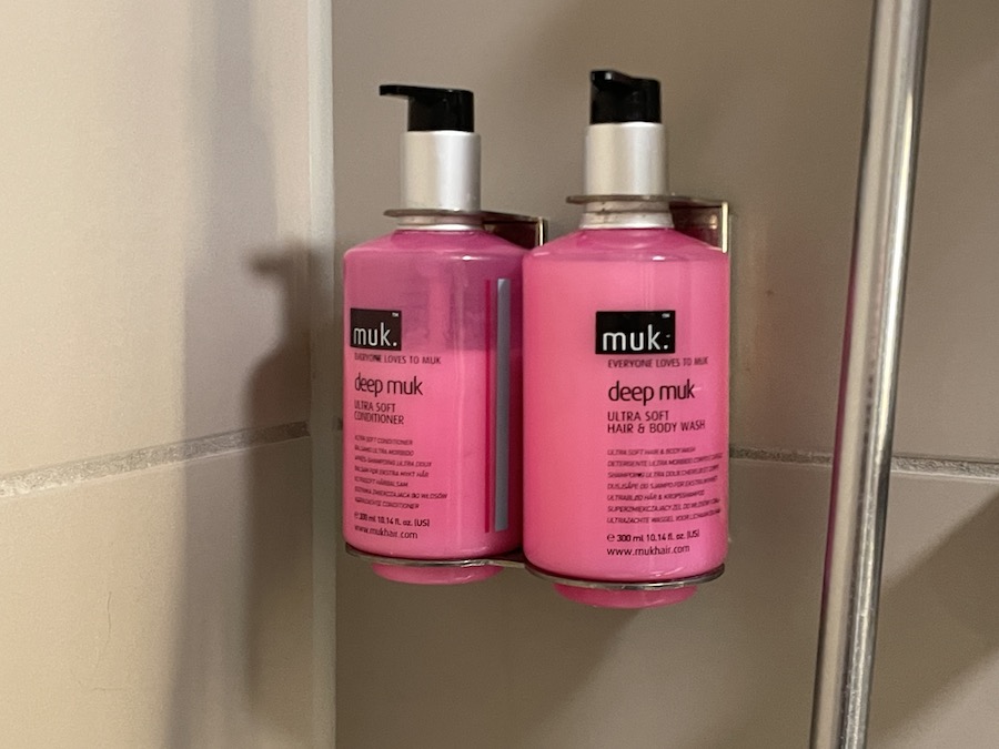 a group of pink bottles of shampoo