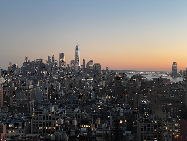 a city skyline with a body of water in the background