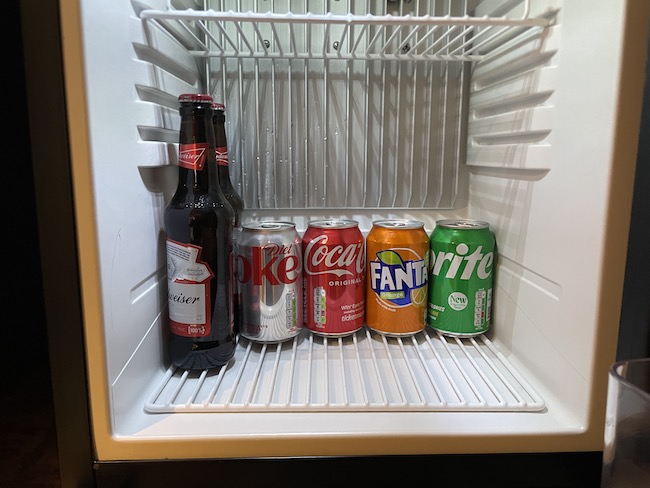 a group of soda cans in a refrigerator