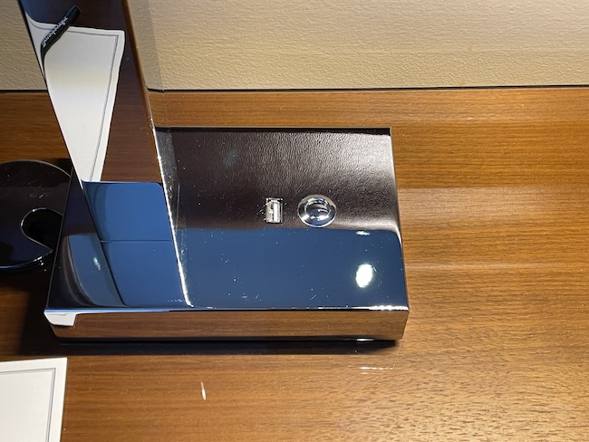 a silver rectangular object on a wood surface