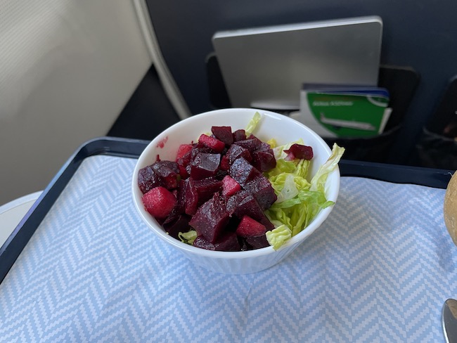 a bowl of salad on a tray