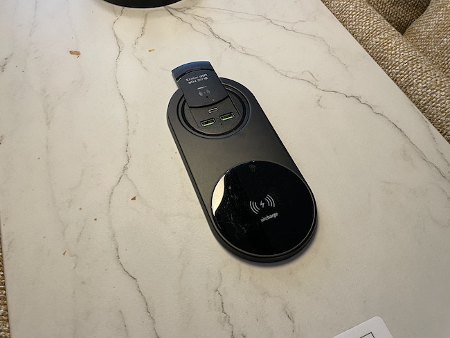 a black wireless charger on a marble surface