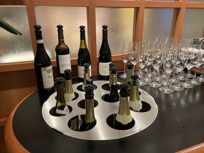 a group of wine bottles and glasses on a table
