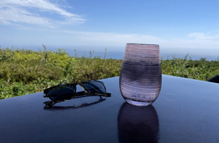 a glass of water and sunglasses on a table