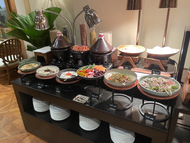 a buffet table with plates of food