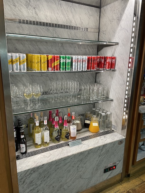 a shelf with drinks and glasses