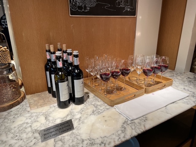 a group of wine glasses and bottles on a counter