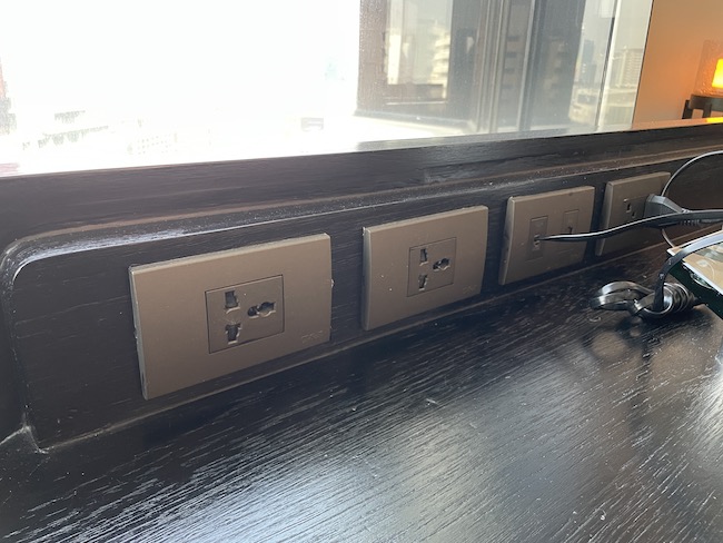 a row of electrical outlets on a wood surface