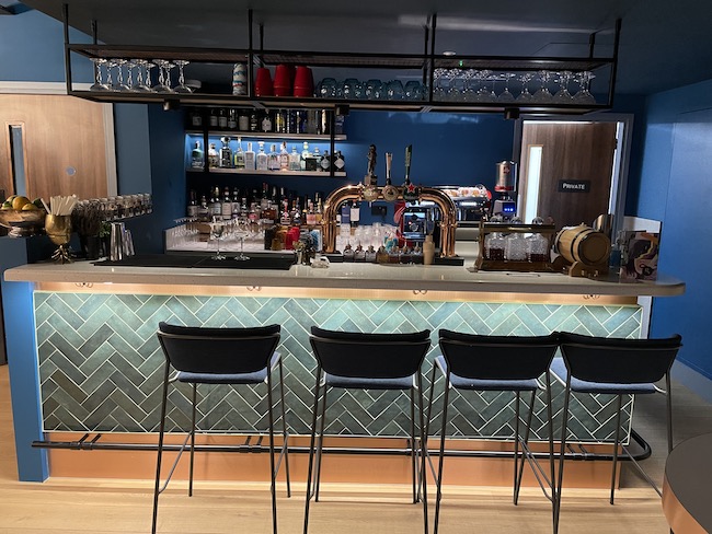 a bar with a row of stools and a bar