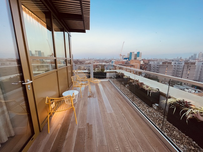 a deck with chairs and a glass railing