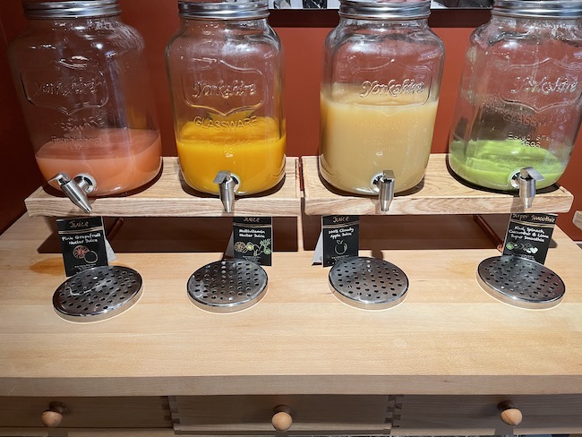 a row of glass jars with different colored liquid in them