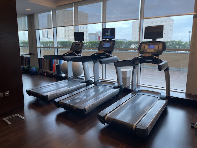 a group of treadmills in a room with a window