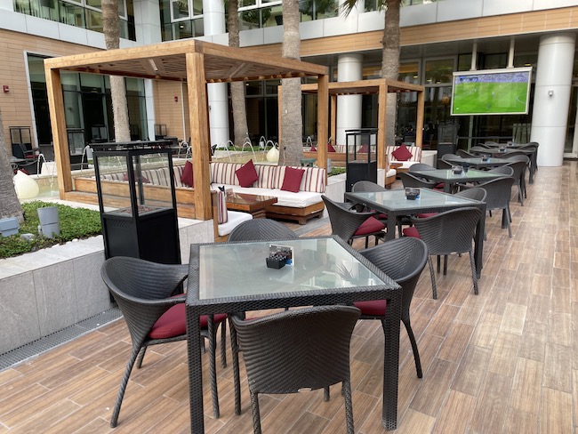 a patio with tables and chairs