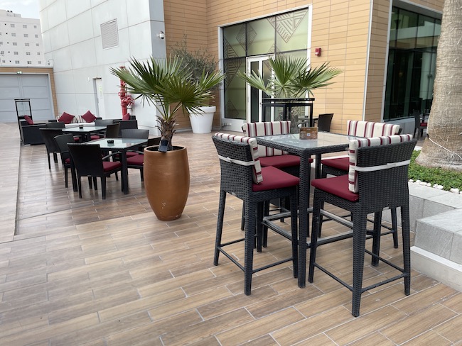 a patio with tables and chairs