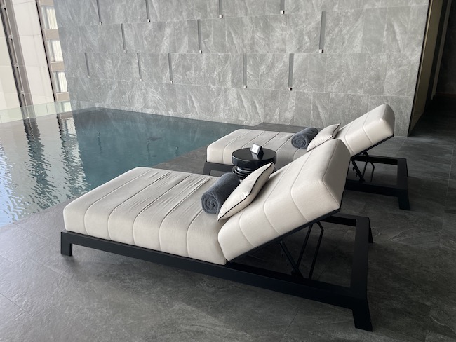 a pool with lounge chairs and a table