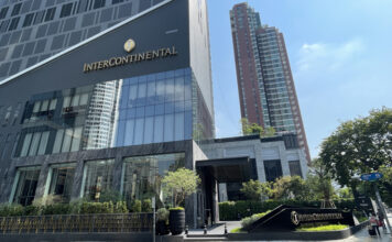 a building with a glass wall and a sign