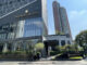 a building with a glass wall and a sign