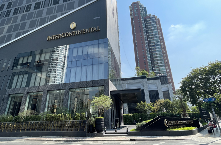 a building with a glass wall and a sign