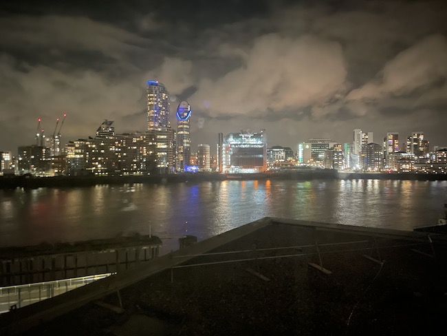 a city skyline at night with a body of water