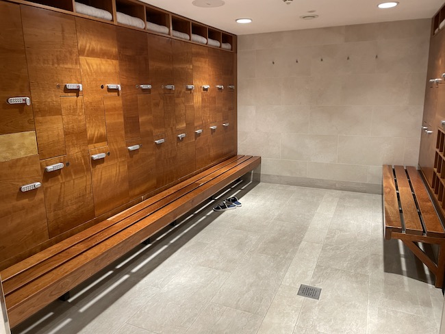 a locker room with a bench and a bench