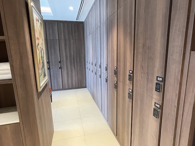 a hallway with lockers and a tile floor