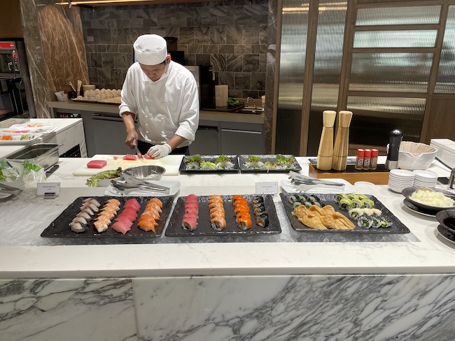 a chef preparing sushi in a kitchen
