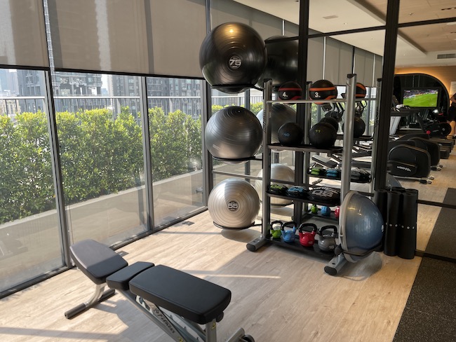 a room with exercise equipment and a bench