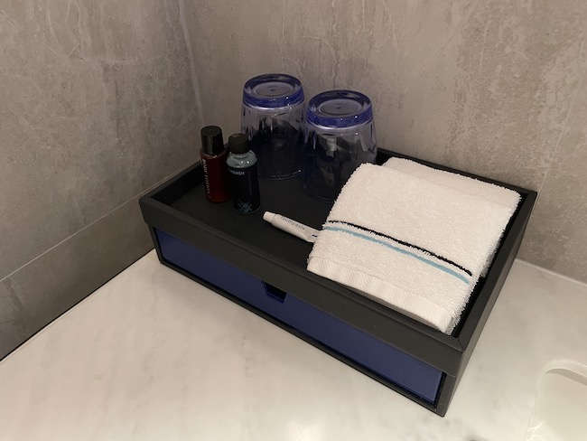 a bathroom tray with a towel and bottles