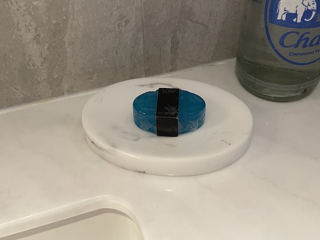 a blue soap on a white counter