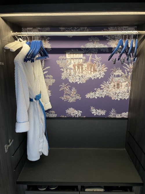 a white robe on swingers in a closet