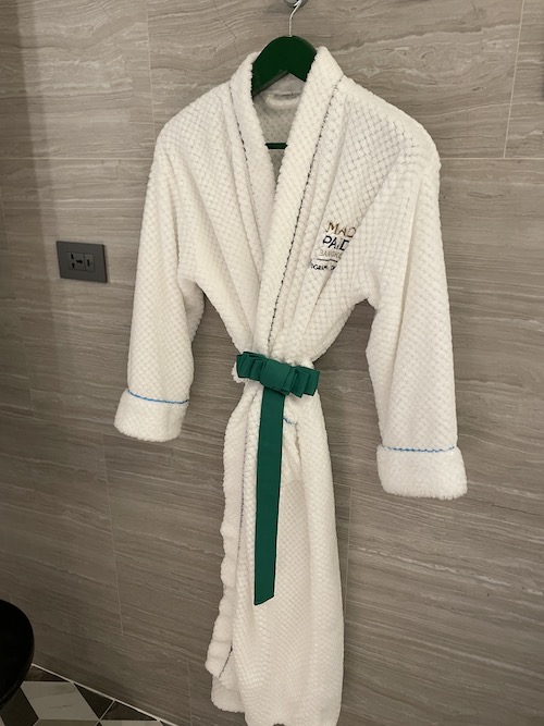 a white robe with a green belt