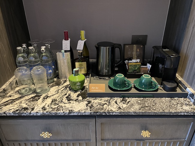 a counter with a variety of coffee cups and saucers