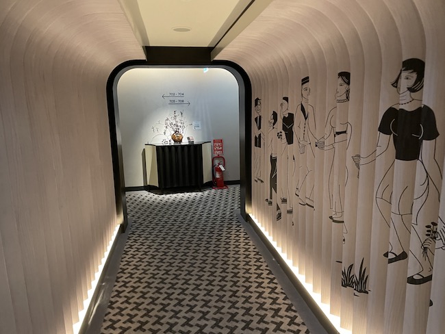 a hallway with a black and white patterned carpet