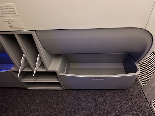 a grey plastic drawer with a shelf